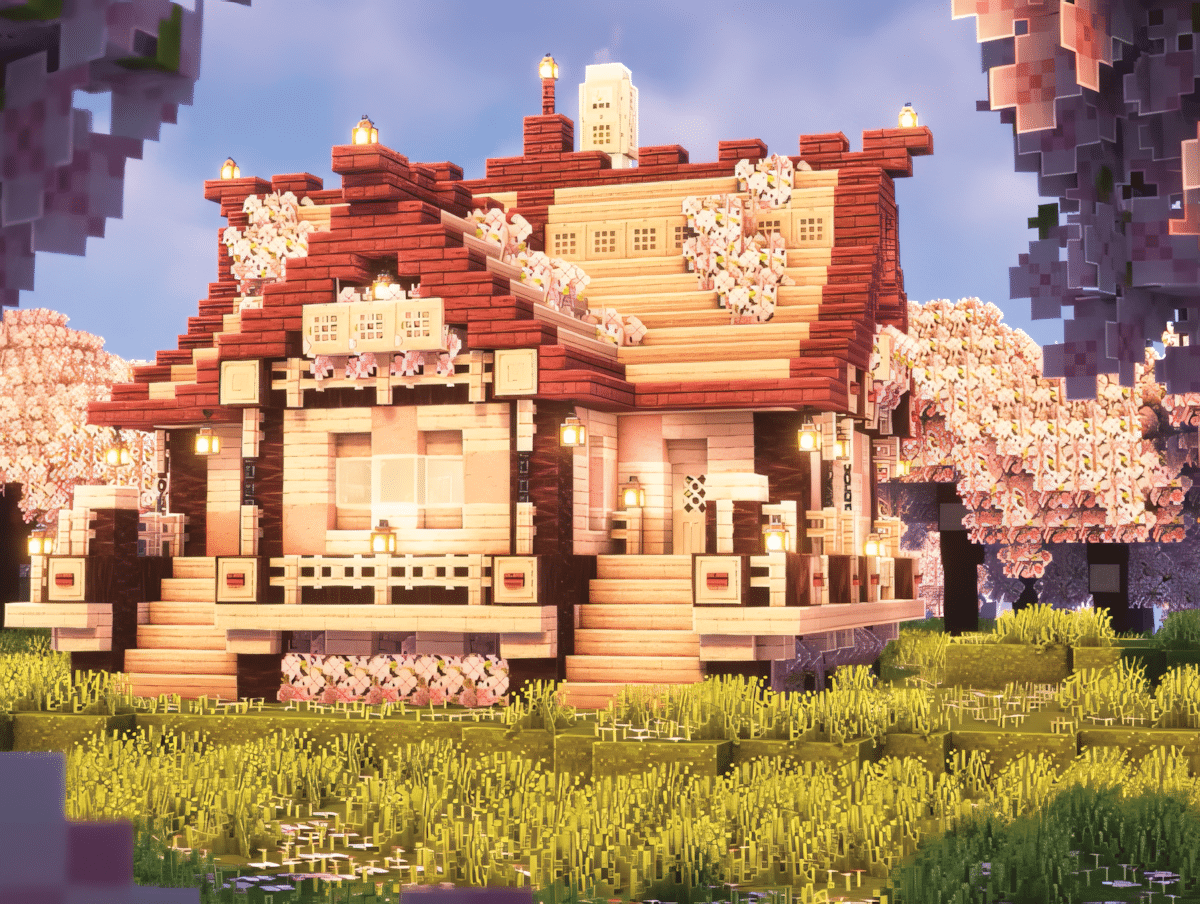 A pink Minecraft farmhouse with cherry wood walls, pink petals on the ground, and surrounding farmland