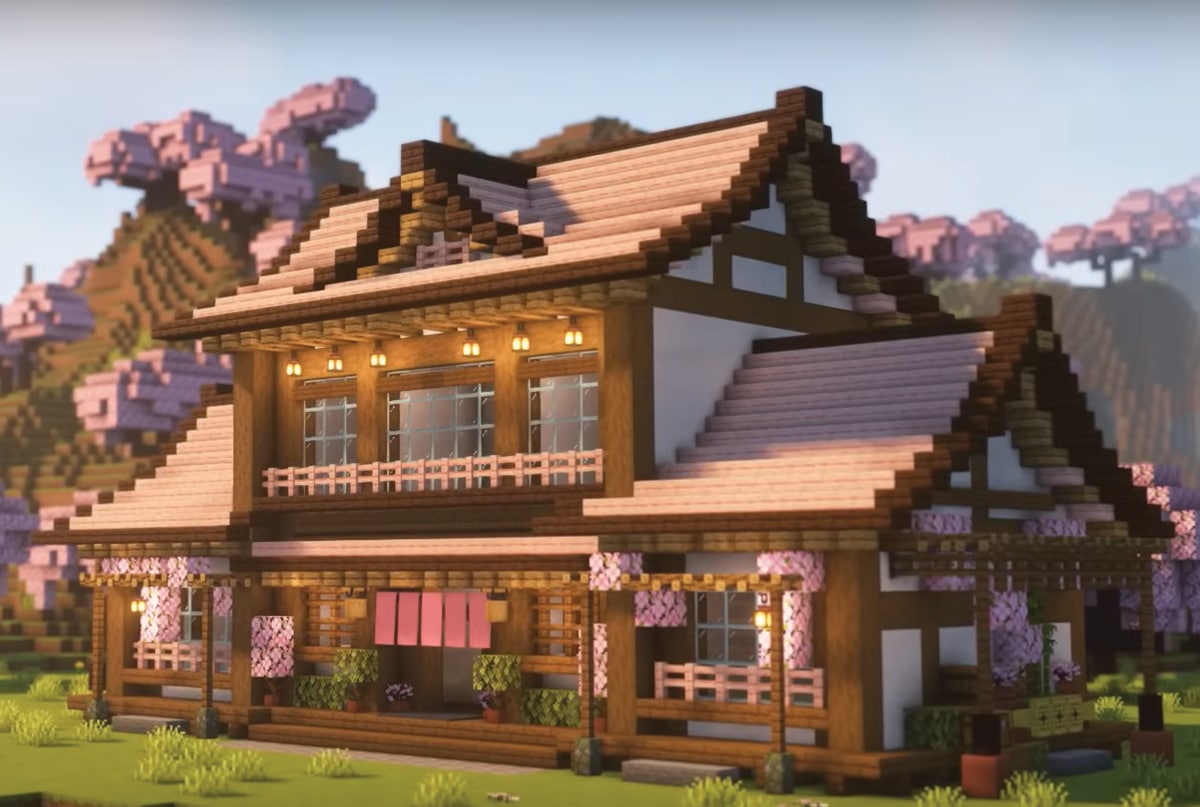 A large Minecraft pink Japanese-style survival house combining cherry blossom and Japanese architectural elements